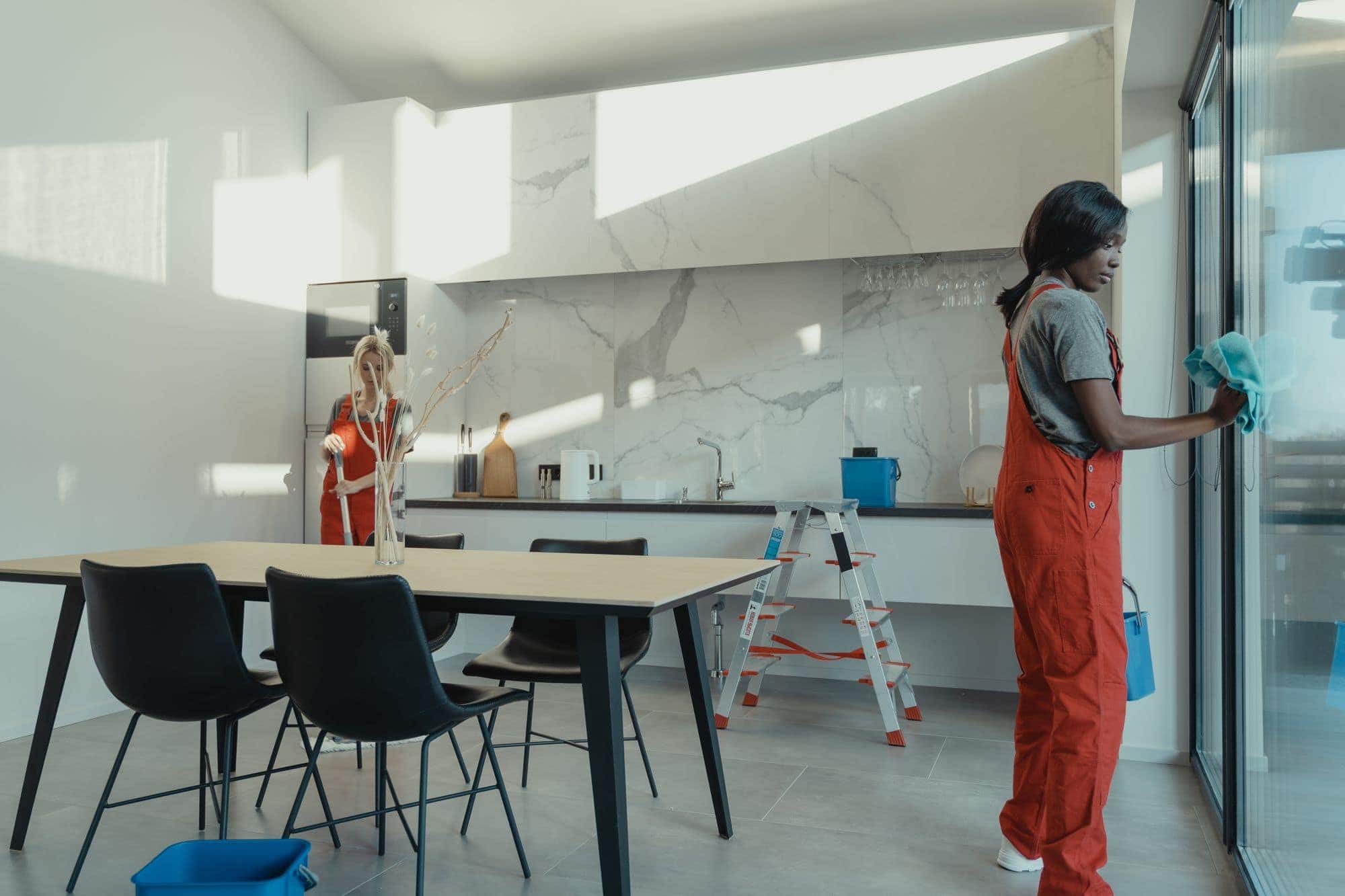 Crew squeegee-finishing a full-height glazing line
